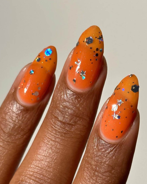 taylor swift tloas nails  orange jelly nails with glitter