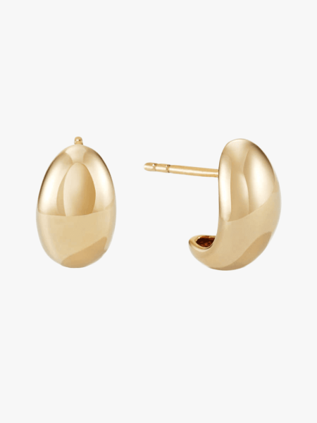 Mejuri Dôme Huggies in gold finish on light gray background